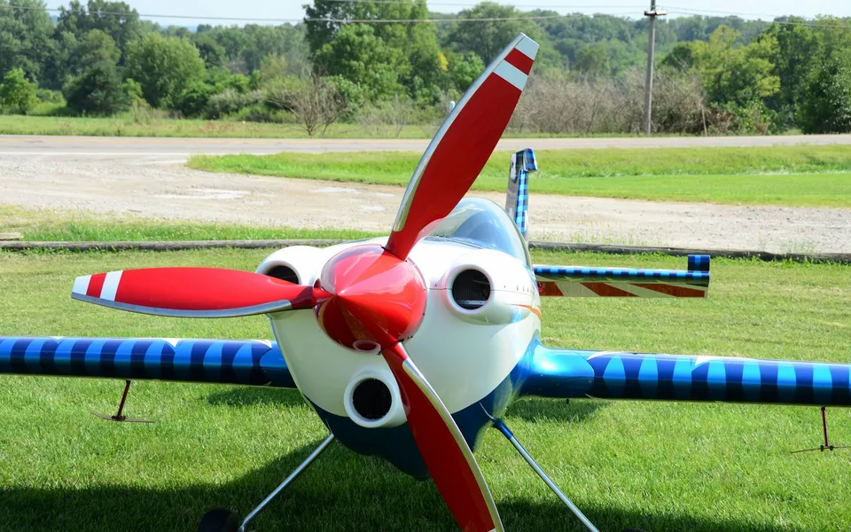 Aerobatic RC plane parked on a flying field